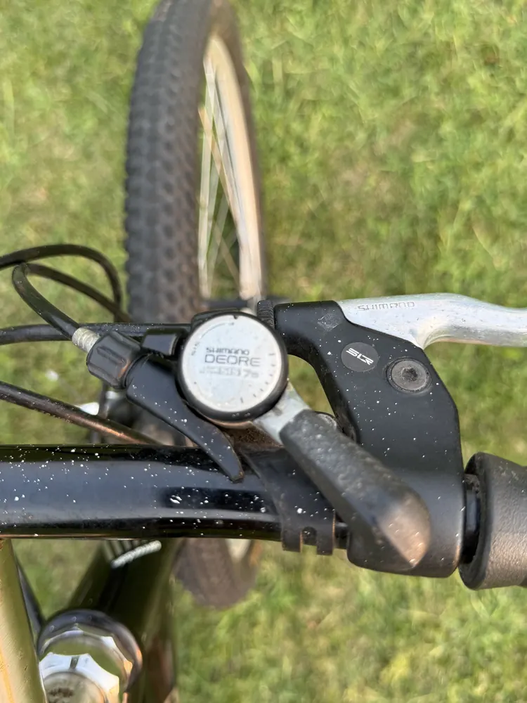 Original Shimano Deore thumb shifter and brake lever.
