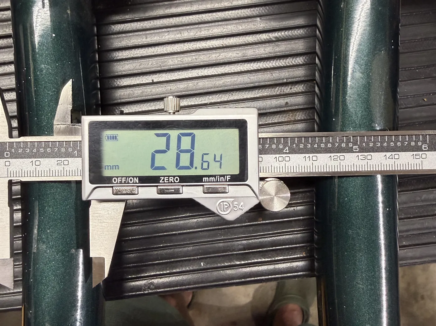 Digital calipers reading 28.64 millimeters across the old quill stem.