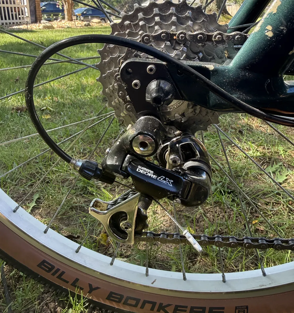The cleaned original seven-speed cassette and Deore LX rear derailleur, above a Billy Bonkers tan-wall tire.
